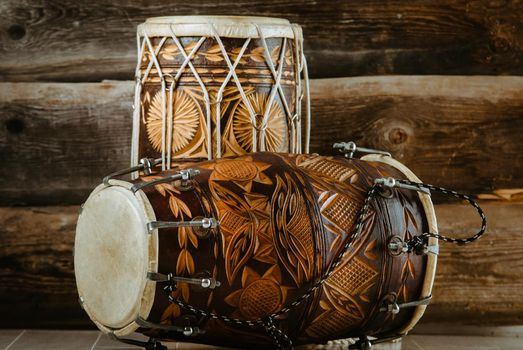 variation of beautiful ethnic indian drums dholak on wooden background