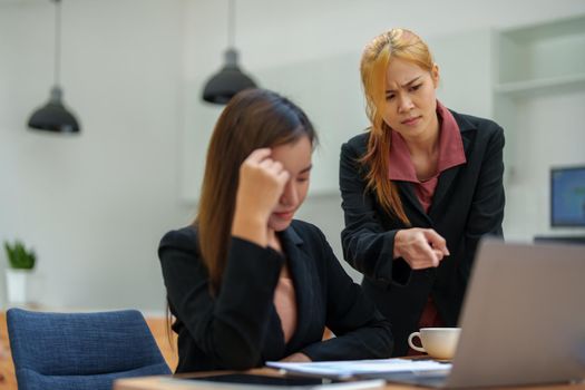 The portrait of an Asian female worker was warned by her supervisor as the profitability sales did not meet the planned targets.