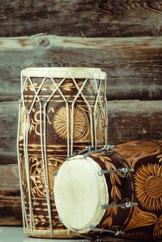 variation of beautiful ethnic indian drums dholak on wooden background