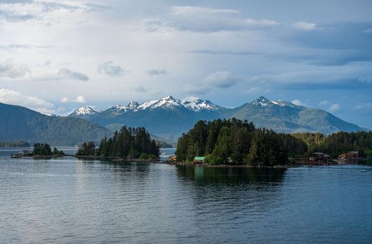 Mountains surrounding the islands of Sitka in Alaska with small homes and cabins