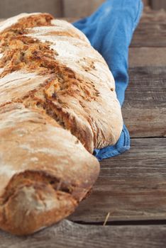 wholegrain fresh homamade bread on wooden roostick background