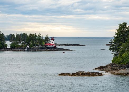 Light house on the rocks on island in the bay of Sitka in Alaska