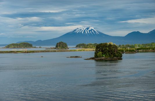 Old volcano of Mt Edgecumbe rises above the islands surrounding Sitka in Alaska
