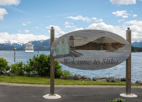 Sitka, AK - 8 June 2022: Viking Orion cruise ship behind Welcome to Sitka sign in Alaska