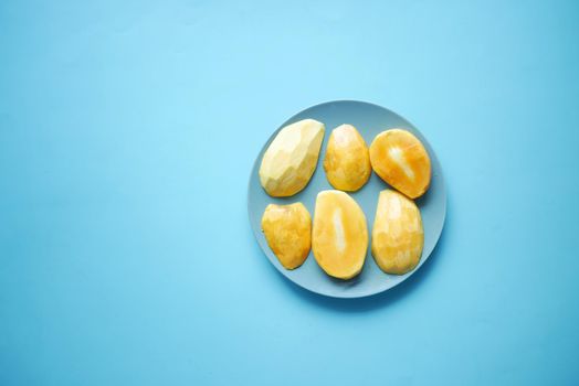yellow ripe cut mango in a bowl top down.