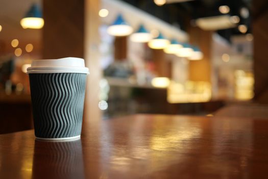 take away paper coffee cup o on cafe table ,