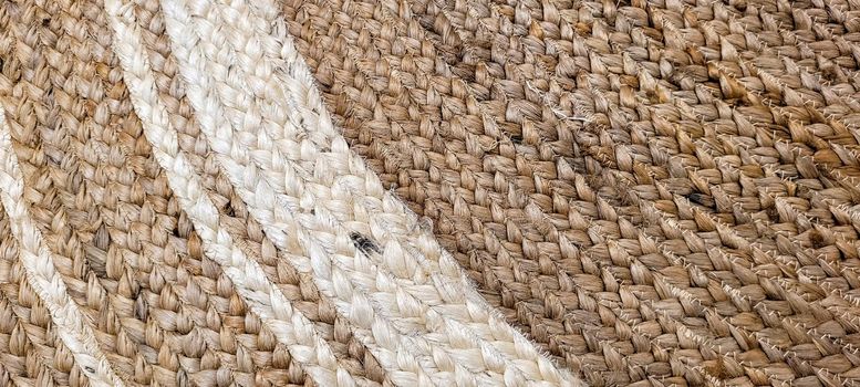 handmade straw rug with white details that can be used as a background