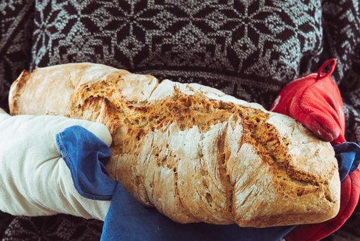 woman carry fresh hot homemade wholegrain bread