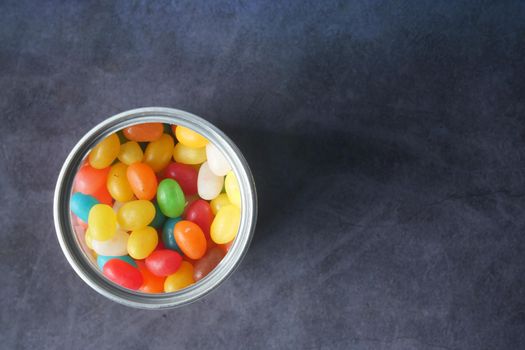 top view of Jelly beans in a bowl on black ,