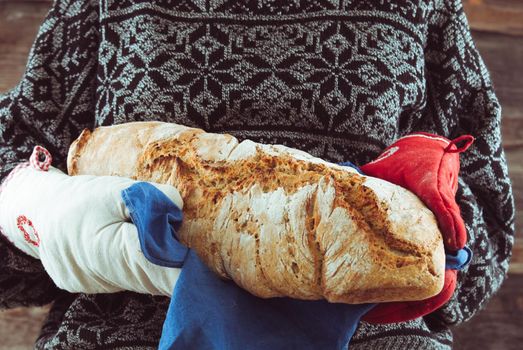 woman carry fresh hot homemade wholegrain bread