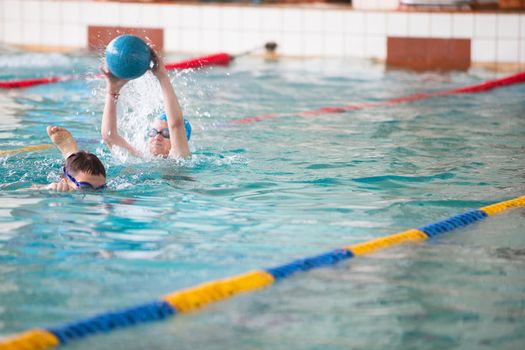 Belarus, Gomel, April 27, 2018. Sports pool. Children's swim training.Children in the pool play ball