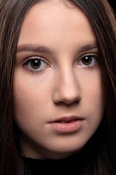 Close-up face of a beautiful young brunette girl.