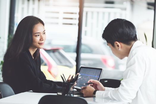 Two business executives are discussing to change their business concept to increase profits and the strength of their business