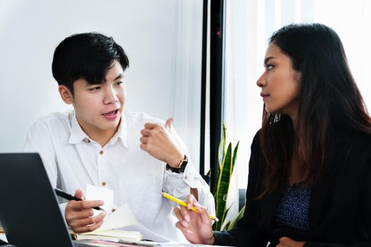 Two young business executives are discussing to change their business concept to increase profits and the strength of their business