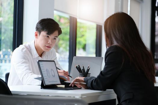 Two young business executives are discussing to change their business concept to increase profits and the strength of their business