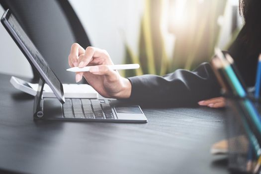 Business woman using tablet to review balance sheet annual and calculating budget in office. audit and Check integrity before investment concept.