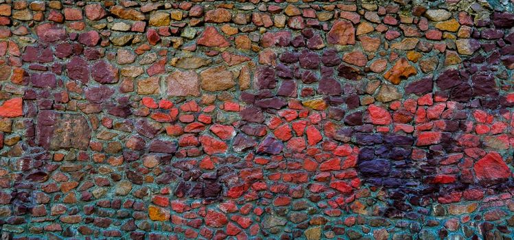 View of the wall of red, blue, brown, purple stones.