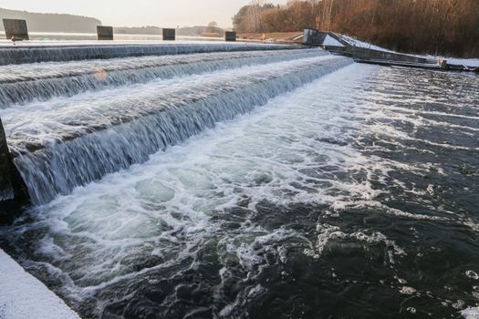 river dam. Dam water release, The waterfall of the river against the background of the forest.