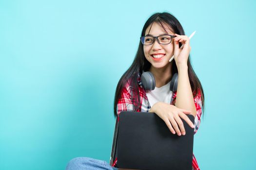 Happy Student. Cheerful Asian Girl Smiling To Camera Standing With Backpack In Studio Over Blue Background. Back to school concept.