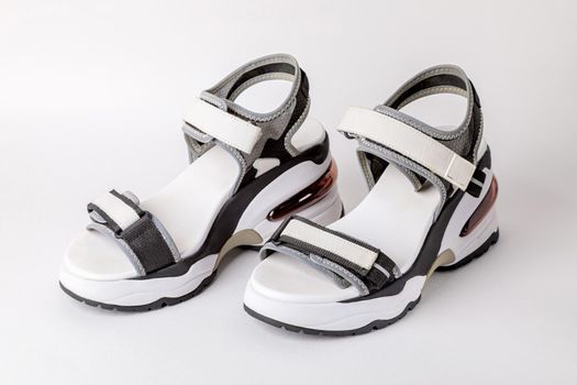 Women's, fashionable, sports sandals on a white background. New youth shoes for girls. Foreground.