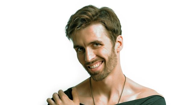 Positive Bearded Man Confidently Looks At Camera, Handsome Toothy Smiles Putting Hand On His Shoulder, Close Up Shot, Positive Young Man With Brown Hair On White Background, Copy Space From Left Side.