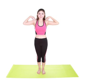 Young woman doing yoga exercise with yoga mat isolated on white background