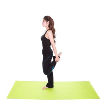 Young woman doing yoga exercise with yoga mat isolated on white background