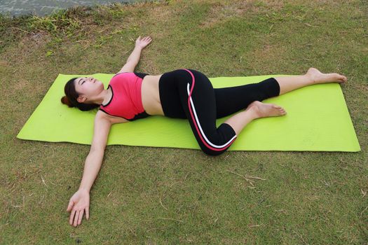 Young woman doing yoga exercise in the park