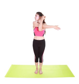 Young woman doing yoga exercise with yoga mat isolated on white background