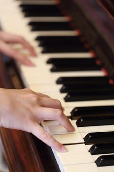Close up of hands playing the classic wood  piano