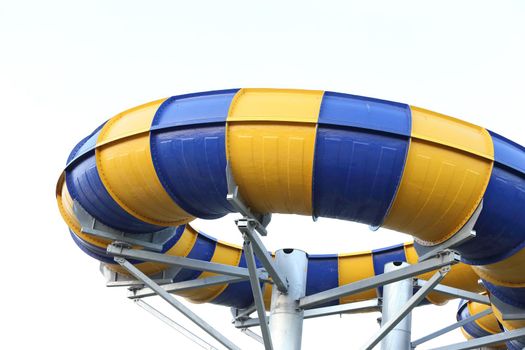 Slider in swimming pool with sky background