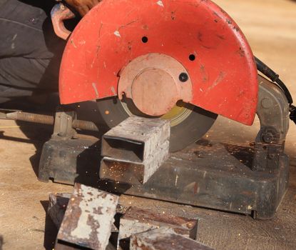 cutting a metal and steel with compound mitre saw with sharp, circular blade