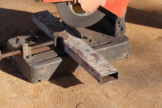 cutting a metal and steel with compound mitre saw with sharp, circular blade