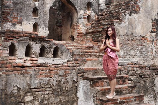 Female pay respect in Thai traditional dress at  historical park