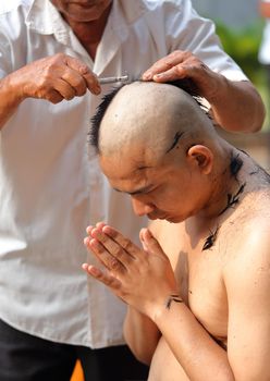 Male who will be monk shaving hair for be Ordained to new monk