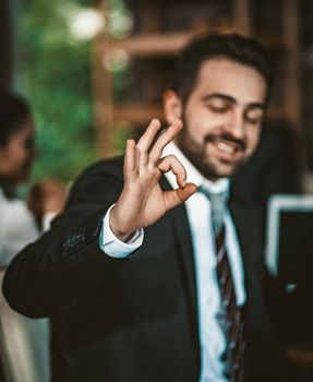 Portrait Of A Businessman Showing Ok Sign, Intelligent Caucasian Man Shows The Okey Gesture Meaning Success And That Everything Will Be Fine, Focus On Male Hand In Foreground, Toned Image