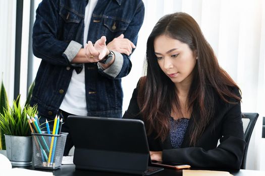 Two young business executives are discussing to change their business concept to increase profits and the strength of their business