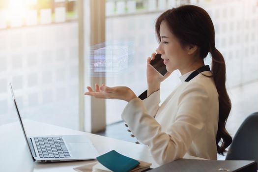 Business woman using computer to trade charts to find buy and sell points for her port