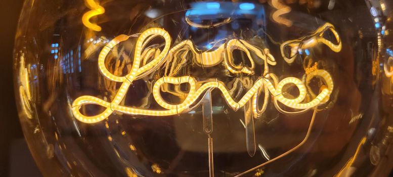 romantic filament lighting with the word love that can be used as a background