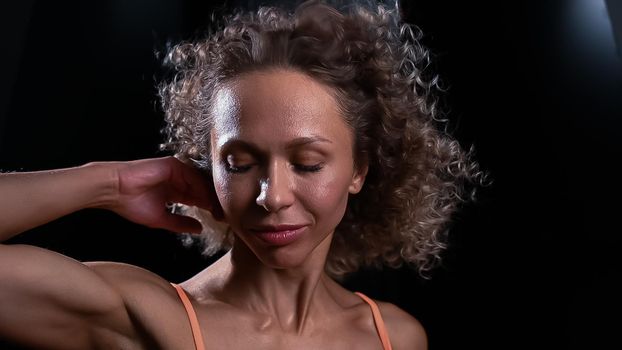 Portrait of a beautiful caucasian woman with curly hair flying in the wind.