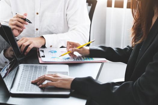 Two young business executives are discussing to change their business concept to increase profits and the strength of their business.