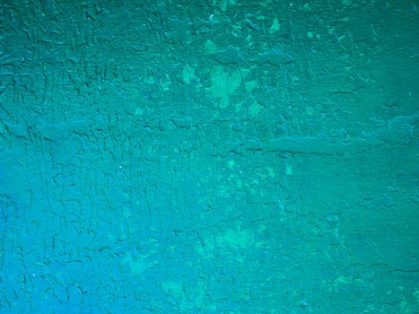 Old green concrete wall with cracked paint, background texture. high quality photo. Metal surface with old damaged green paint.