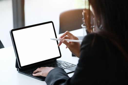 Business Women use a tablet for work, a blank tablet screen can add text or other media