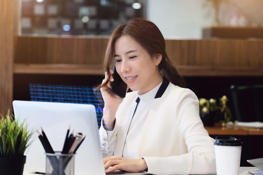 digital technology, Business woman using computer laptop to trade charts to find buy and sell points for her port.