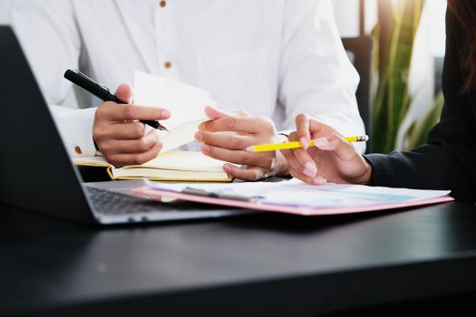 Two young business executives are discussing to change their business concept to increase profits and the strength of their business