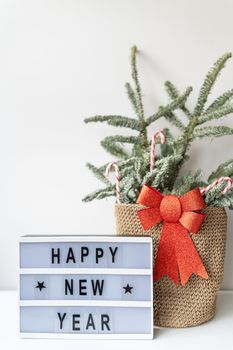 Happy New Year on vintage lightbox with New Years Eve decoration, concept image. Nobilis in a basket of candies