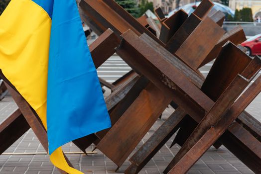 The Ukrainian flag hangs on barricades on the street