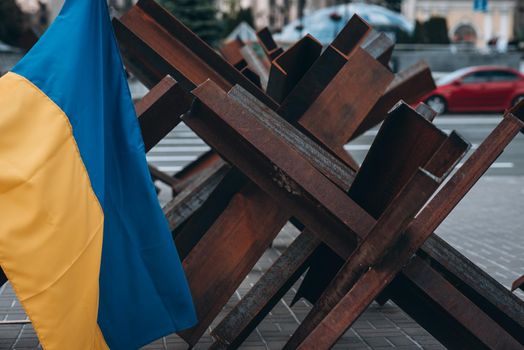 The Ukrainian flag hangs on barricades on the street