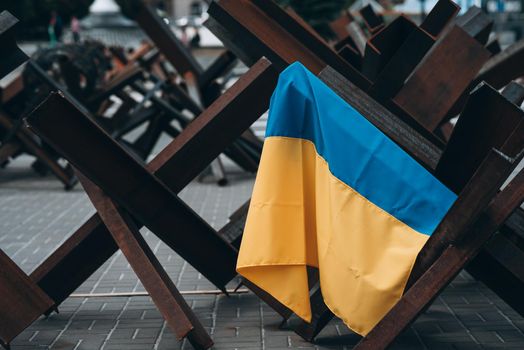The Ukrainian flag hangs on barricades on the street
