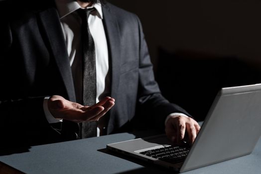 Man Typing Important Data Into Laptop And Presenting New Idea Over Hand.